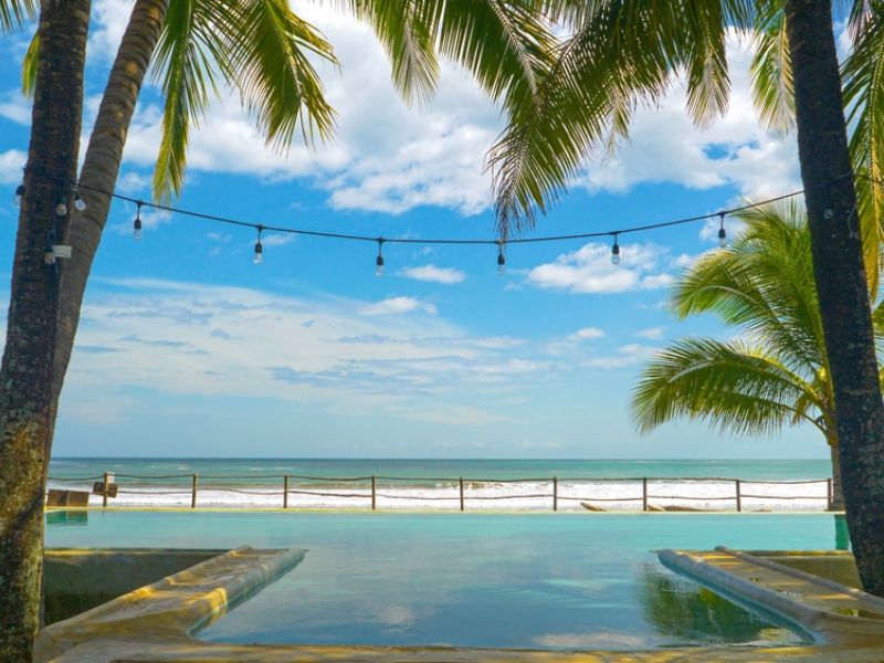 real estate in pedasi panama with palm trees and a view overlooking the beach